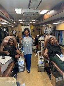 Employees of the firm donating blood at blood drive