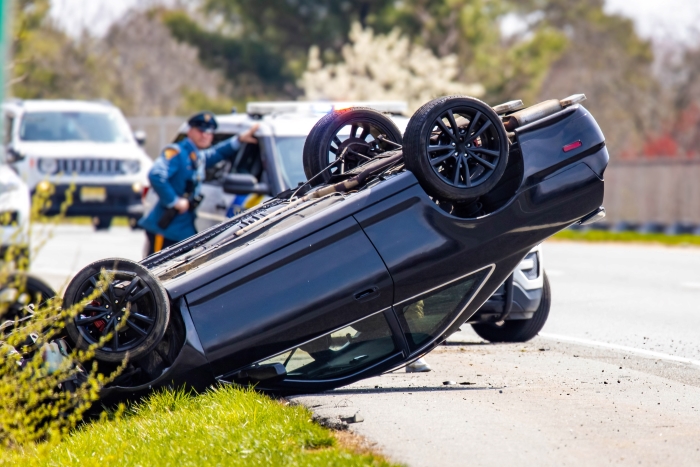 Vehicle rollover highway road accident with police in the back